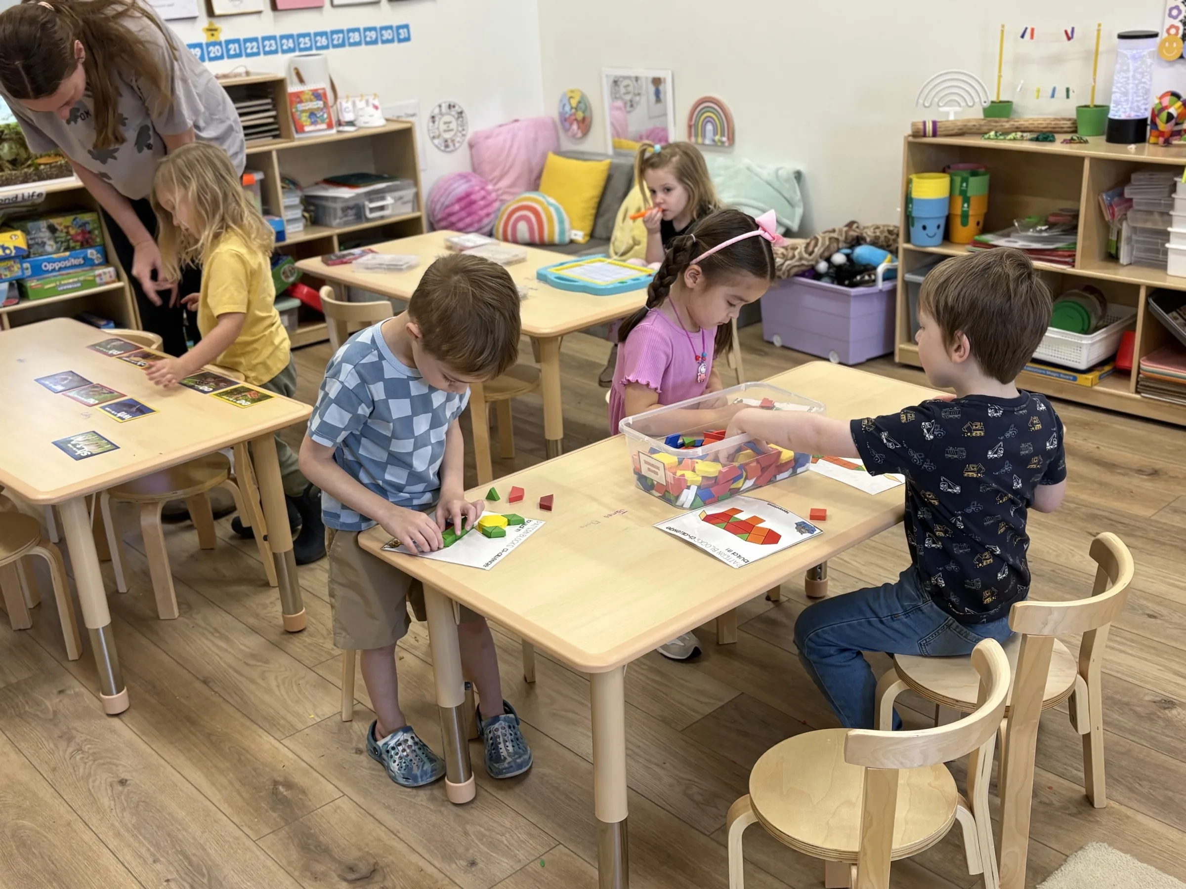 Preschool students engaged in purposeful play at learning stations in a Spark Academy classroom